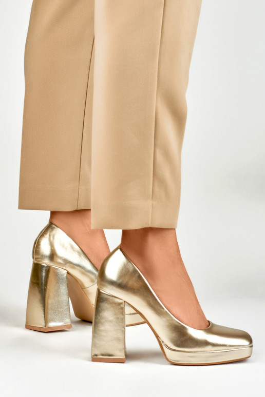 High heels with a wide heel in gold...