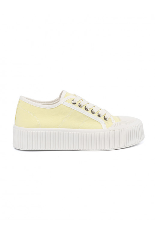 yellow shoes laced on a thick sole