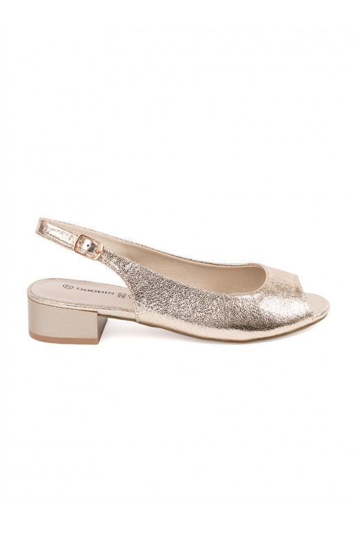 gold color sandals on a low heel